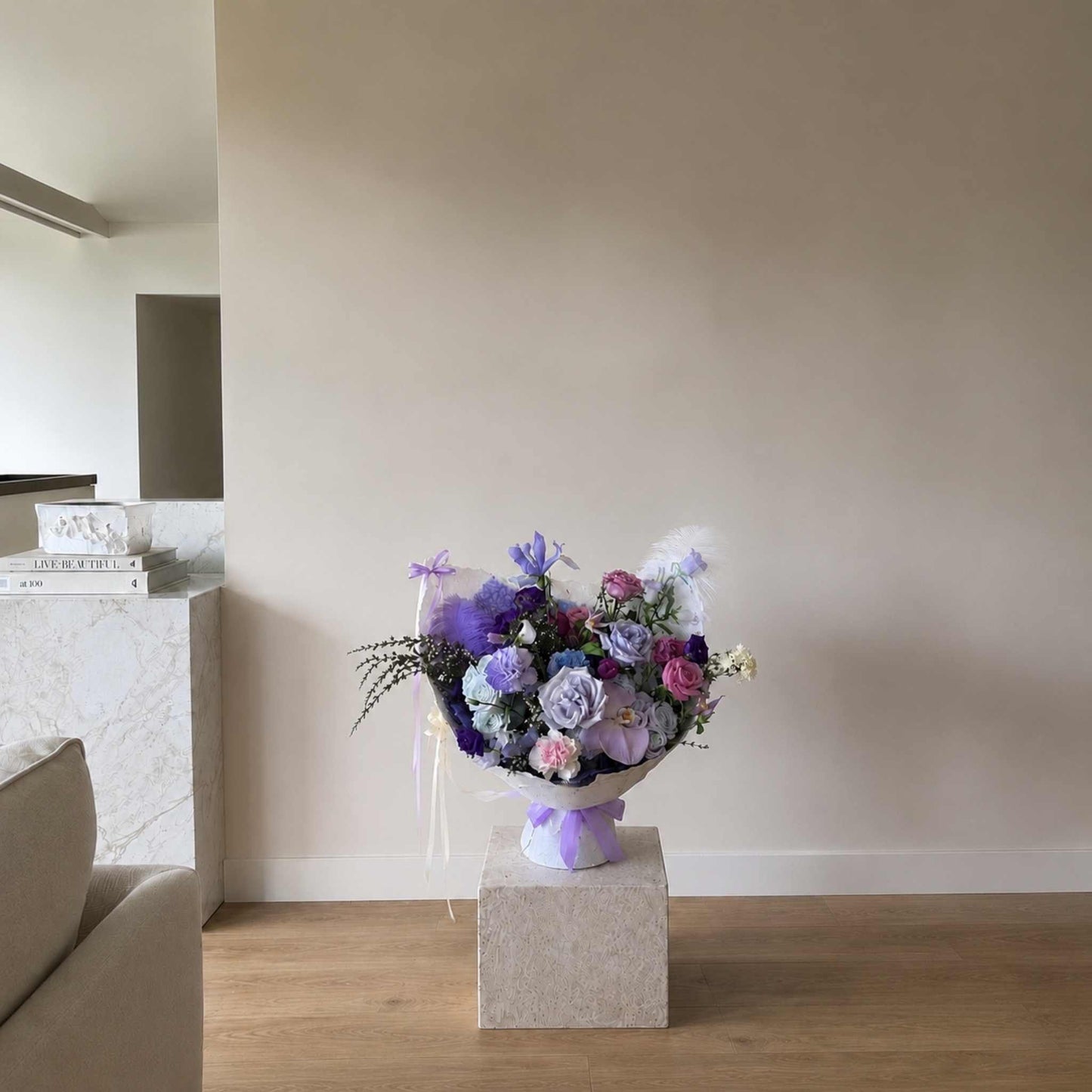 Bouquet of flowers on a pedestal in a room with neutral decor