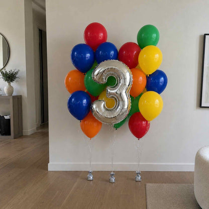 Colorful balloons with a silver number '3' in a living room setting.