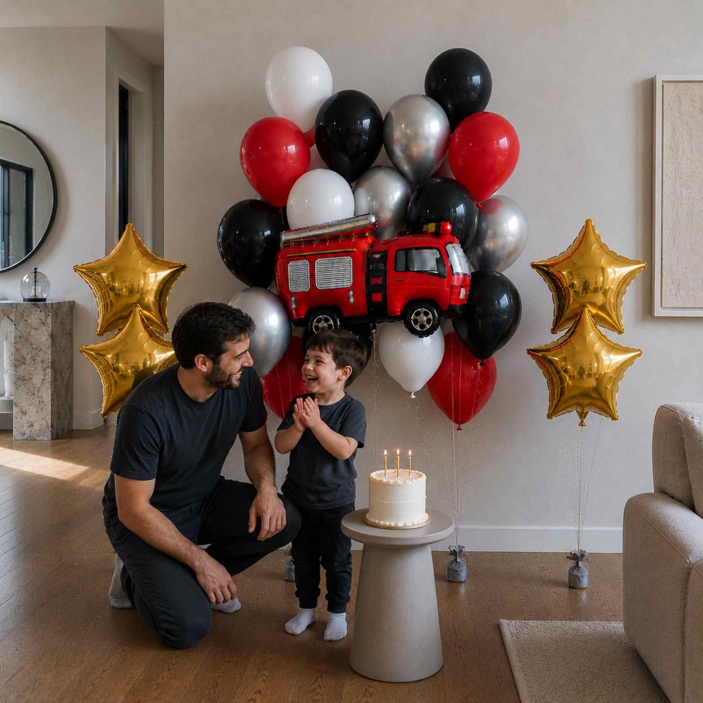 Man and child with a fire truck balloon bouquet and birthday cake in a living room.