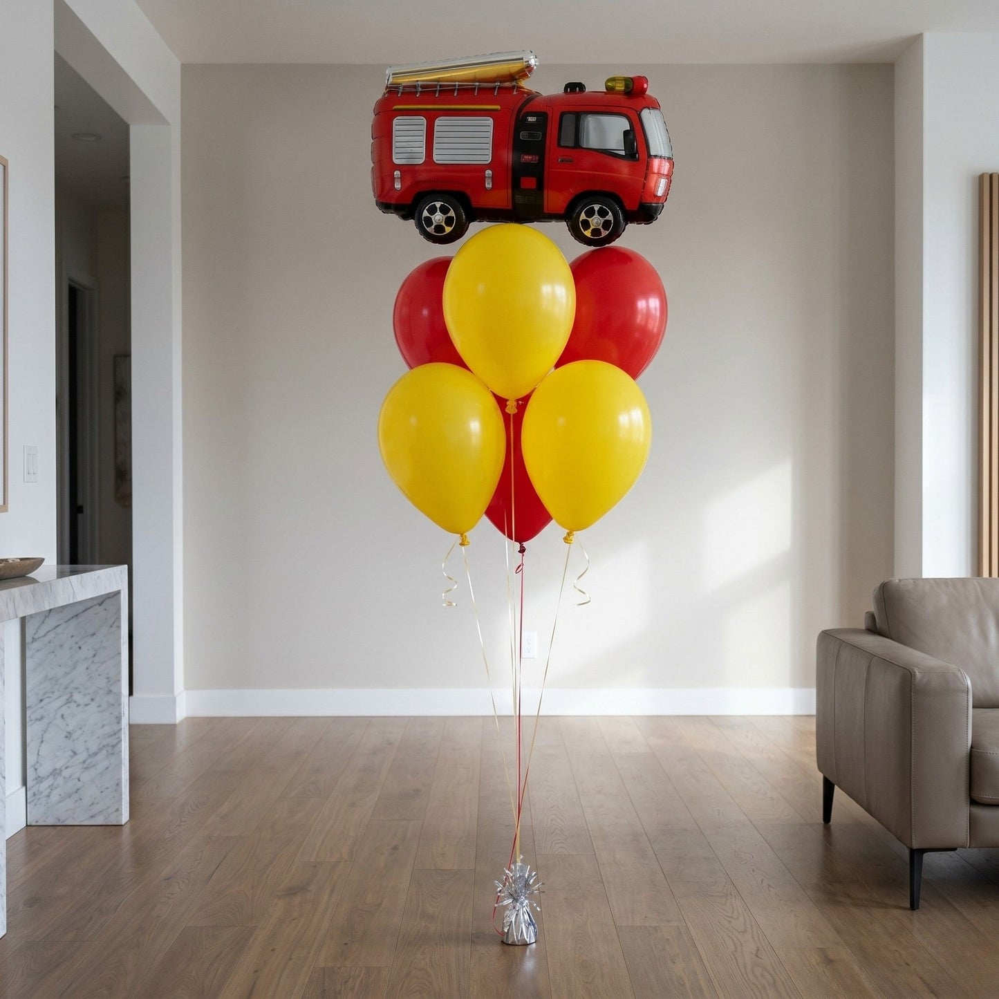 A balloon fire truck is in the apartment.It has many balloons.
