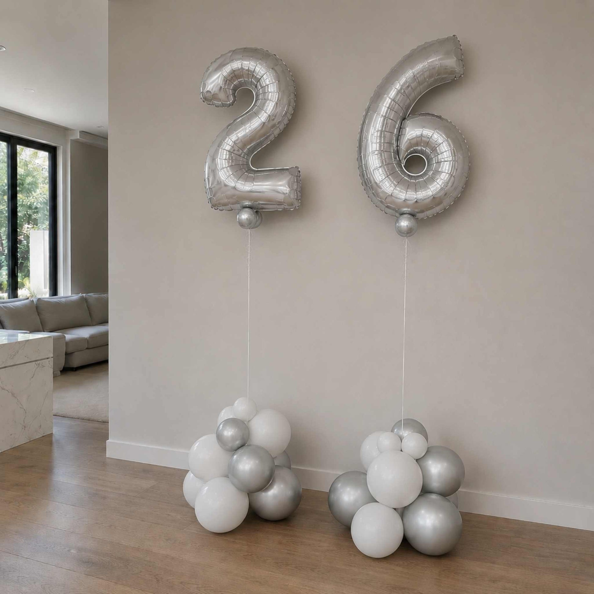 Silver number balloons '26' in a living room setting