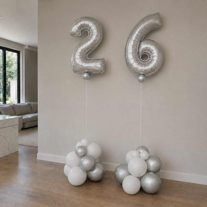 Silver number balloons '26' in a living room setting