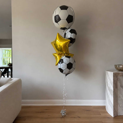 Soccer ball and star-shaped balloons in a living room setting.