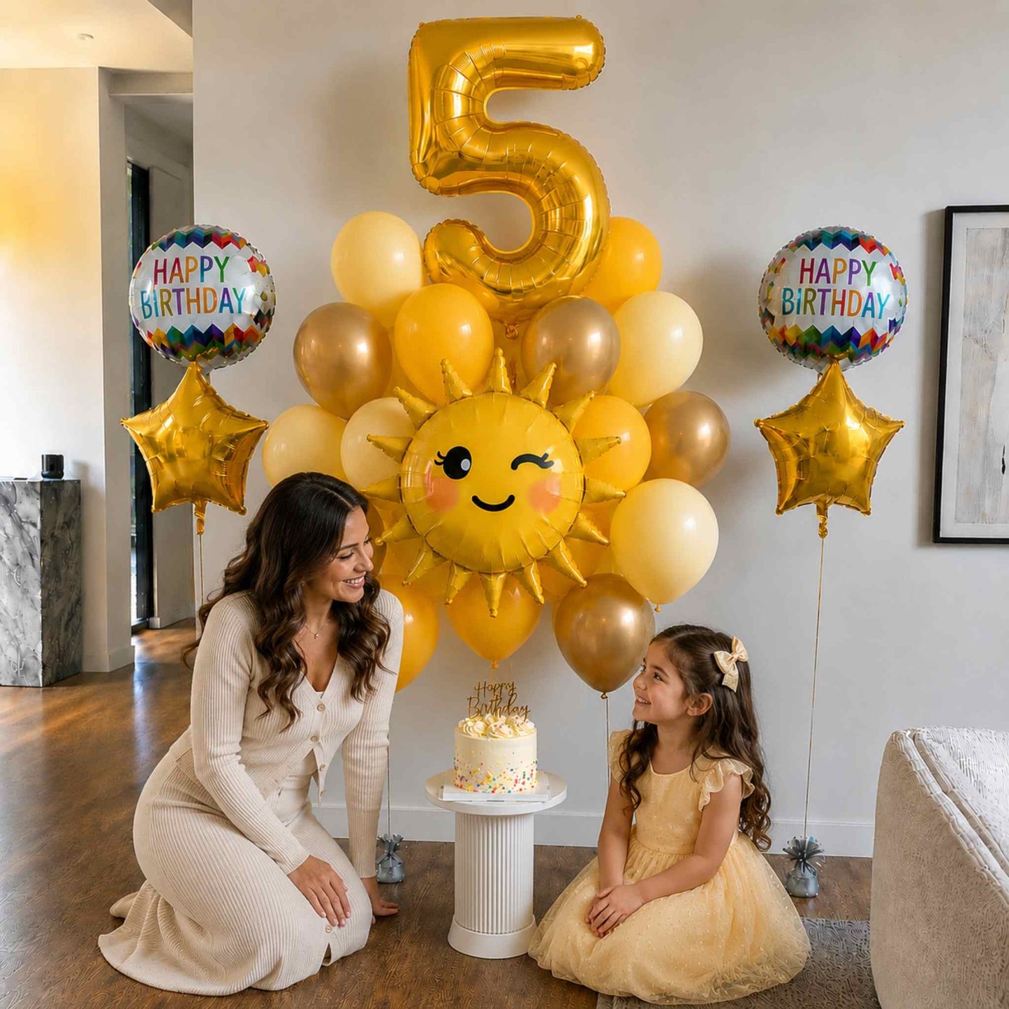 Woman and child with birthday balloons and cake in a room