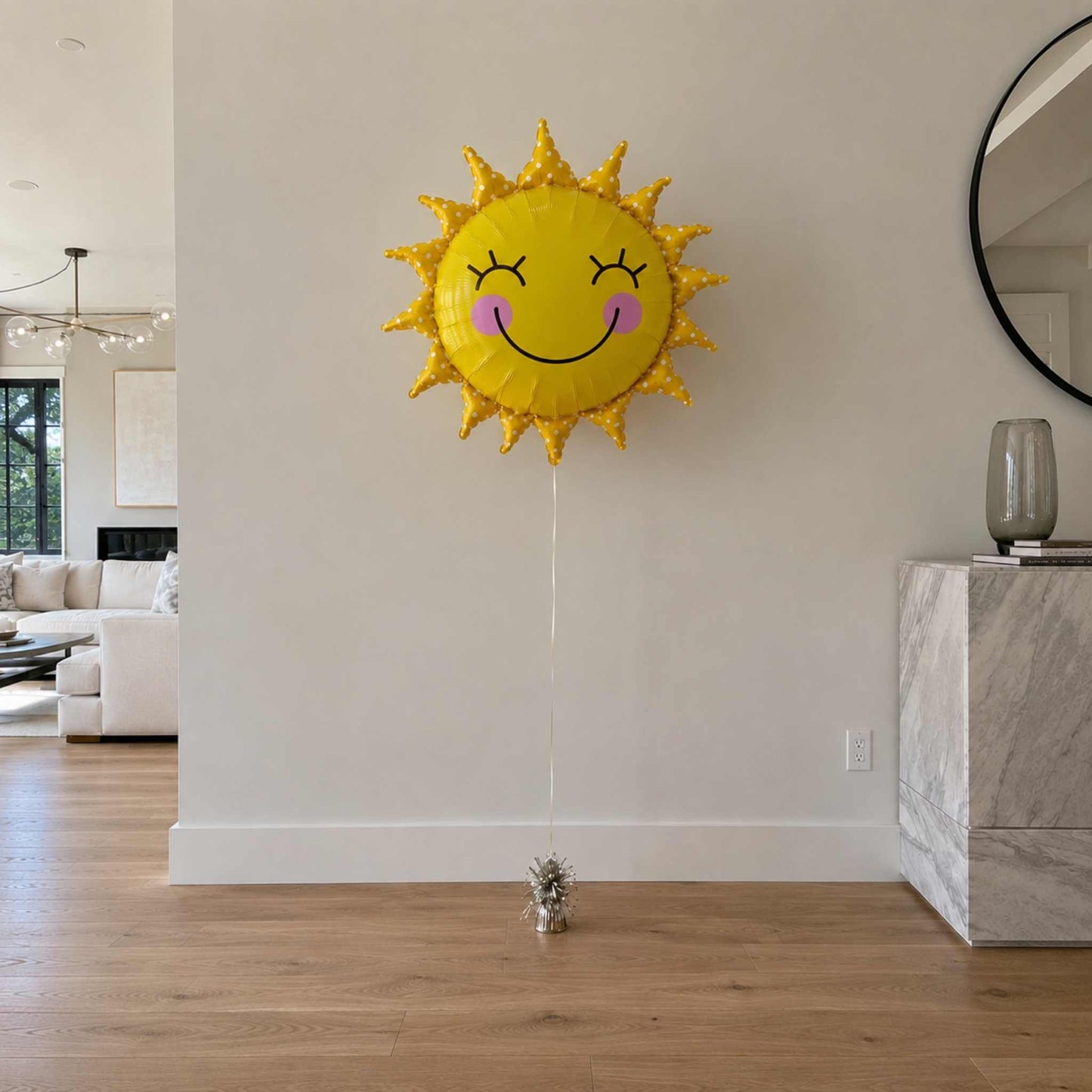 Sun-shaped balloon with a face in a living room setting