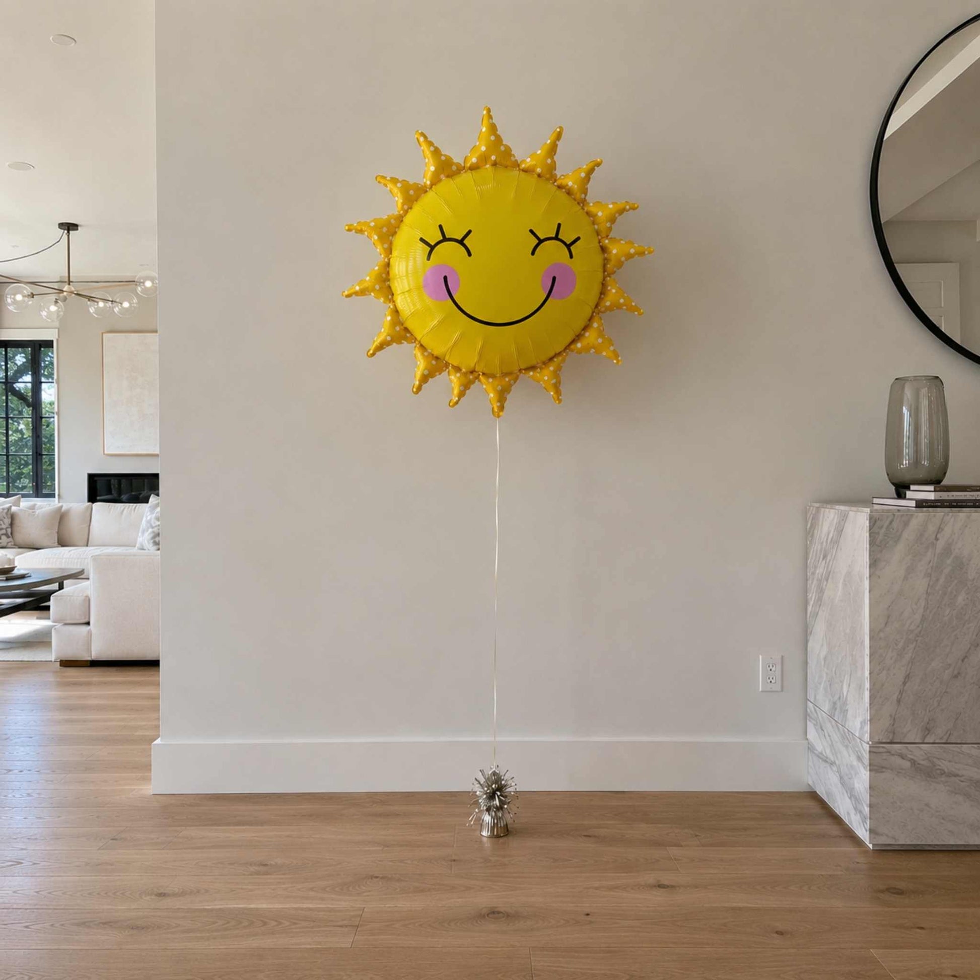 Sun-shaped balloon with a face in a living room setting