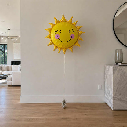 Sun-shaped balloon with a face in a living room setting