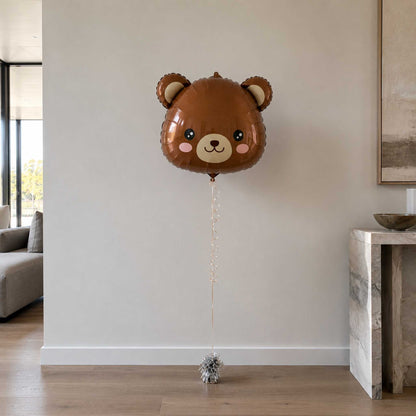 Brown bear-shaped balloon in a living room setting