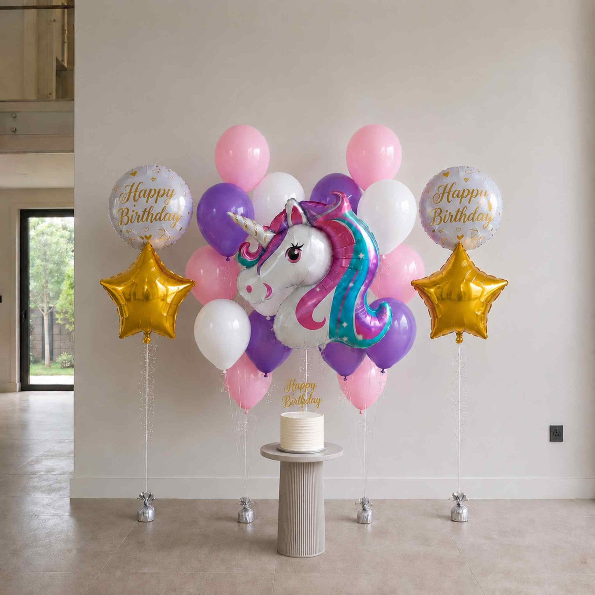 Balloon arrangement with unicorn and stars for a birthday celebration indoors.