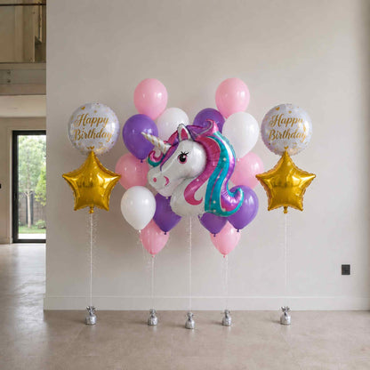 Balloon arrangement with unicorn and stars for a birthday celebration indoors.