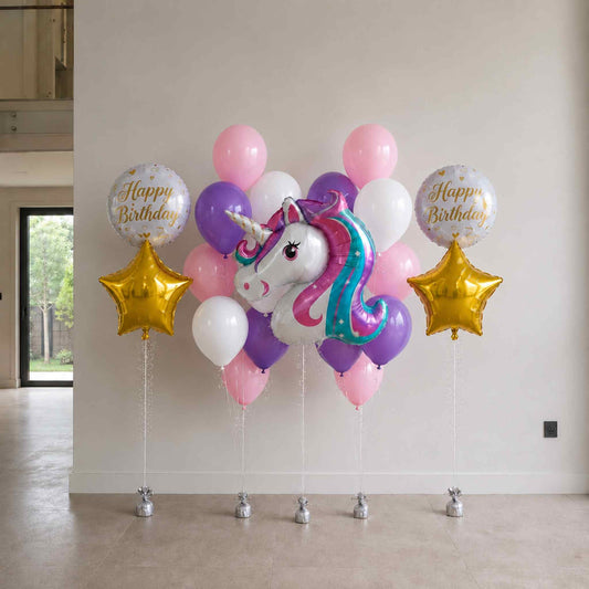 Balloon arrangement with unicorn and stars for a birthday celebration indoors.