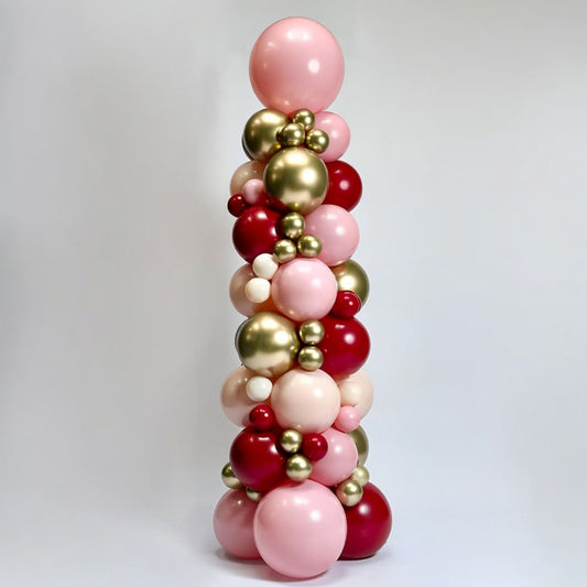 Balloon column with pink, gold, and red balloons on a white background