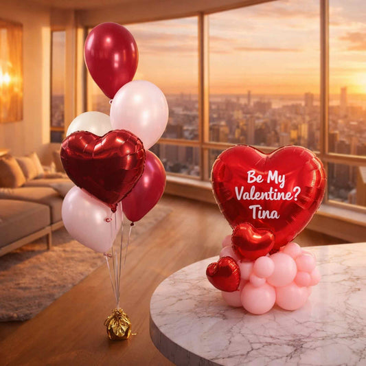 Heart-shaped balloons with 'Be My Valentine? Tina' message in a living room with a cityscape view.