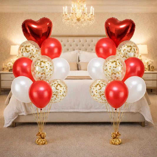 Decorative balloons in red, white, and gold on a bed in a bedroom setting.