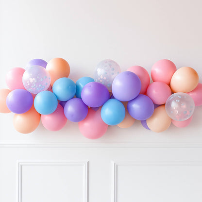 Colorful balloon garland against a white wall