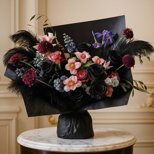 Bouquet of flowers with black paper wrap on a marble surface