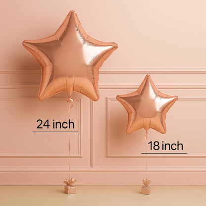 Two rose gold star-shaped balloons with measurements on a beige wall background