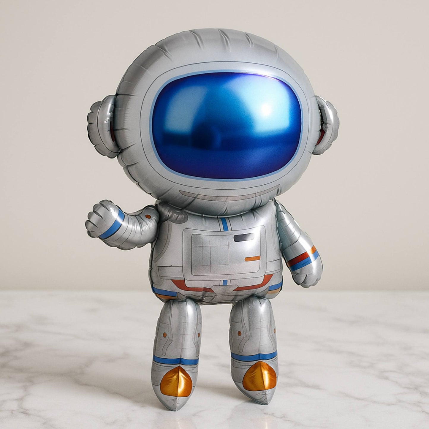 Astronaut-shaped balloon on a marble surface with a light gray background