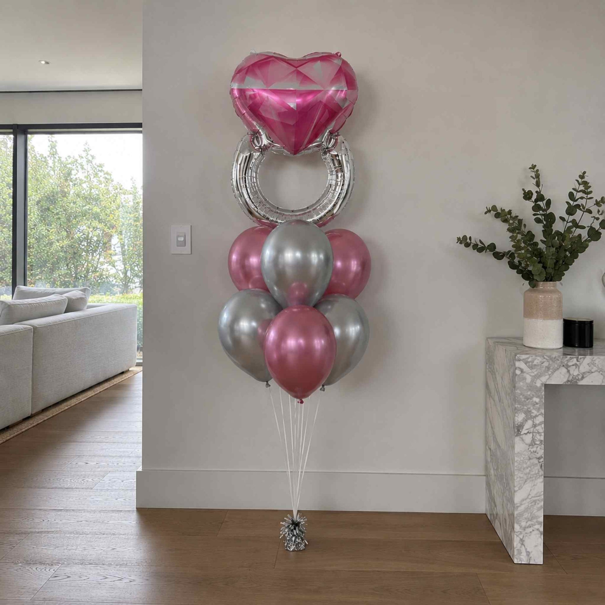 Decorative balloons in pink and silver in a living room setting