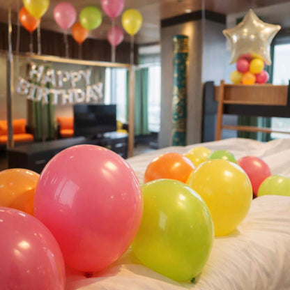 Colorful balloons on a bed with 'Happy Birthday' banner in a room.