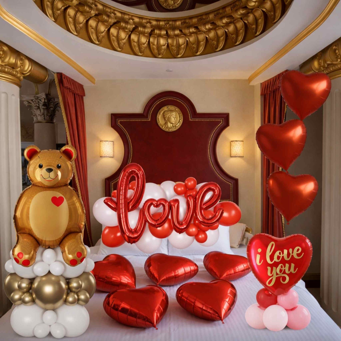 Decorative setup with balloons and a teddy bear in a room with ornate ceiling and bed.