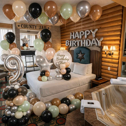Birthday decorations with balloons and 'Happy Birthday' sign in a living room.