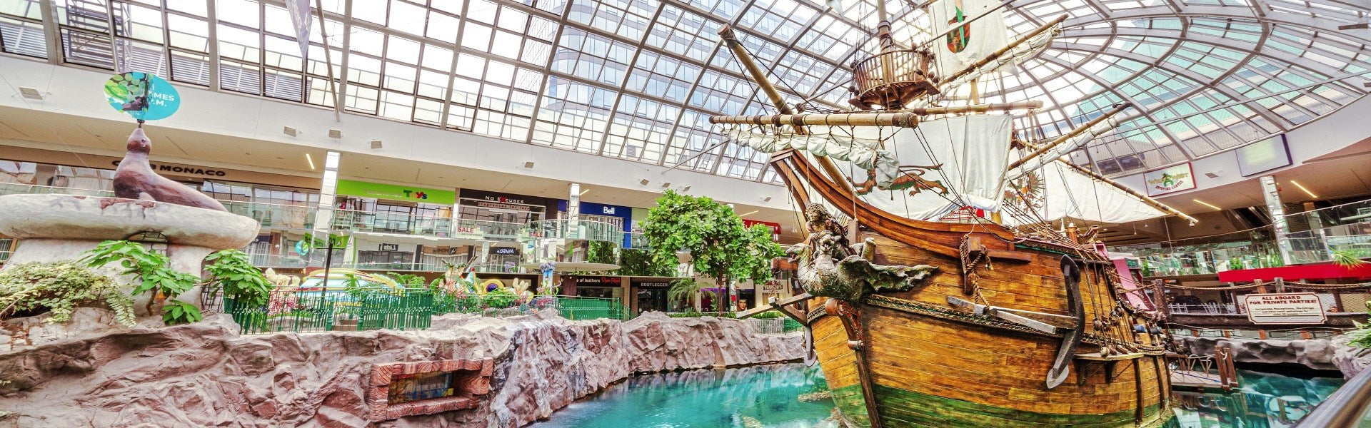 Pirate ship and fountain inside a shopping mall with large glass ceiling