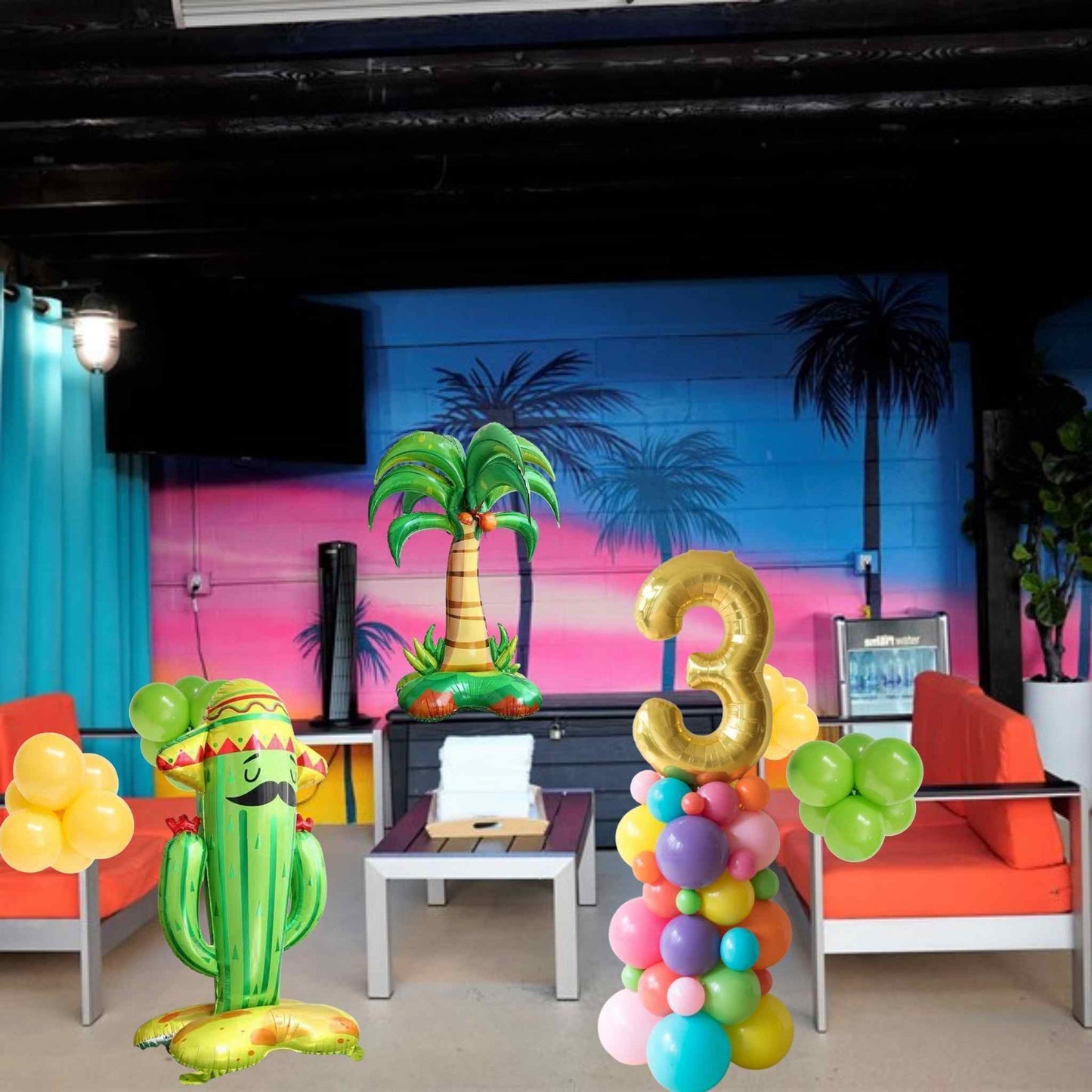 Decorated room with colorful balloons, a cactus-shaped balloon, and a number '3' decoration.