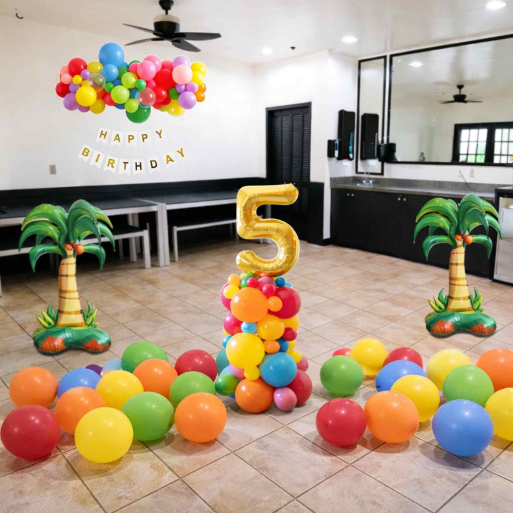 Colorful birthday decorations with balloons and number '5' in a room.
