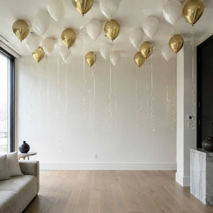 Gold and white balloons hanging from the ceiling in a modern living room.