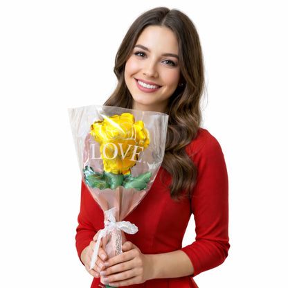 Woman holding a bouquet of yellow roses with 'LOVE' written on it against a white background