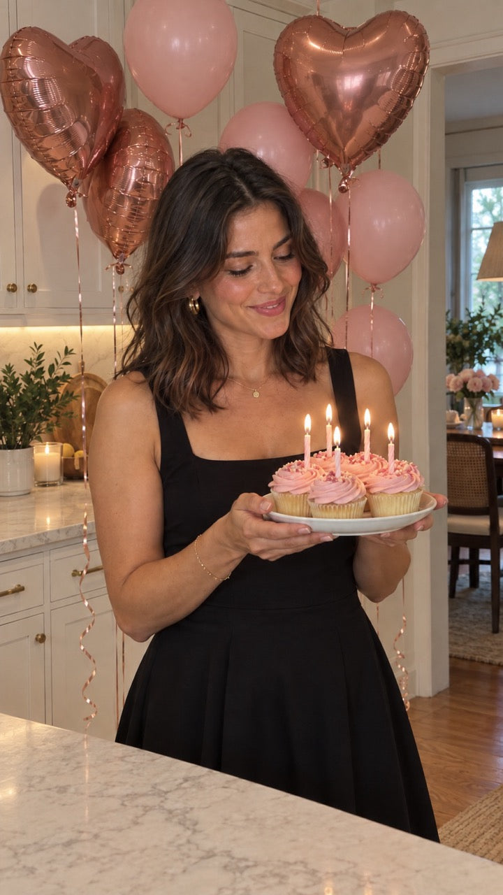 woman with pink balloons and rose gold hearts, marble table top in a large house
